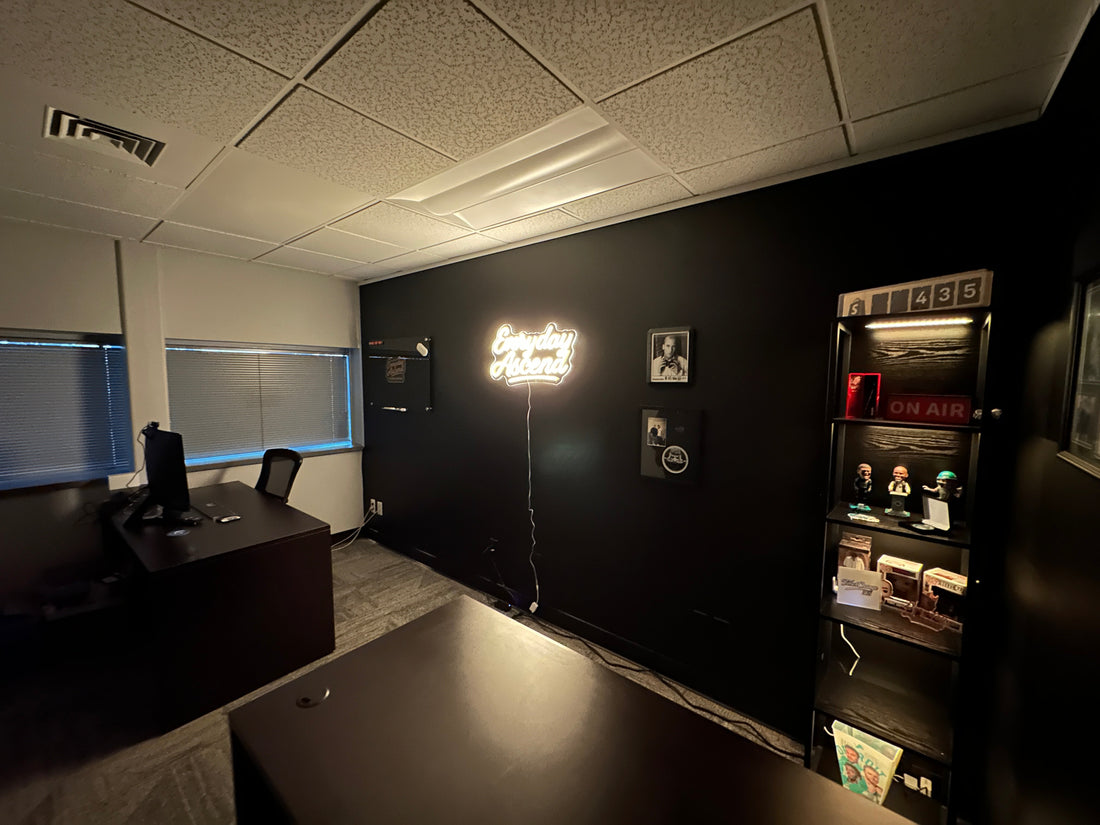 Everyday Ascend office space with illuminated brand sign representing intentional growth and founder mindset